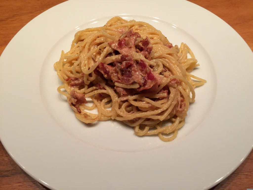 spaghetti carbonara dish beautifully plated with a savory tomato and meat sauce.