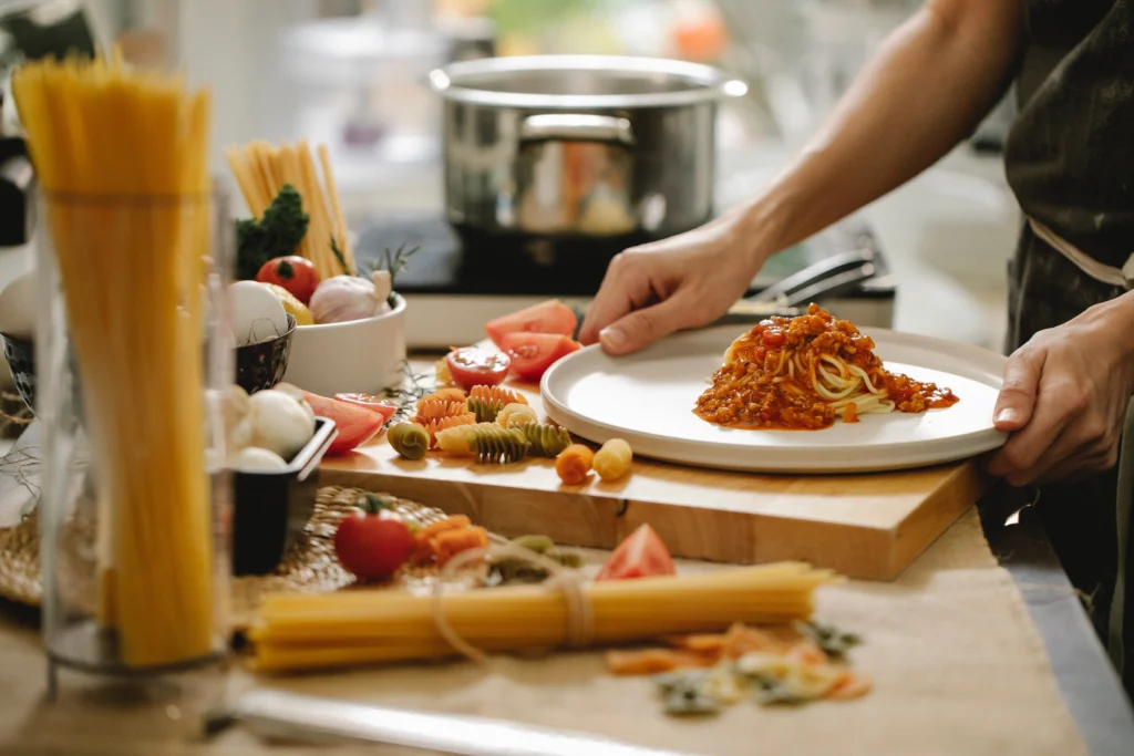 spaghetti carbonara dish beautifully plated with a savory tomato and meat sauce. The warm, bokeh background lighting adds a cozy and inviting atmosphere, making it perfect for showcasing a hearty and flavorful meal.