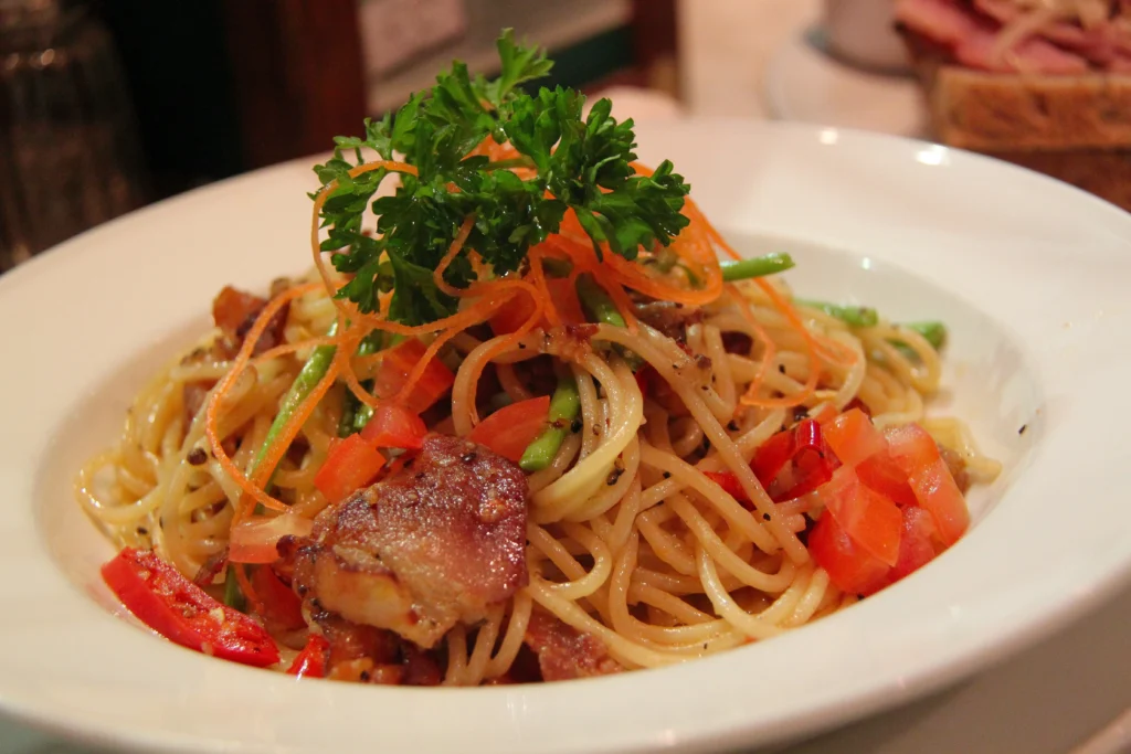 delicious plate of spaghetti, The dish is elegantly garnished with freshly chopped herbs.