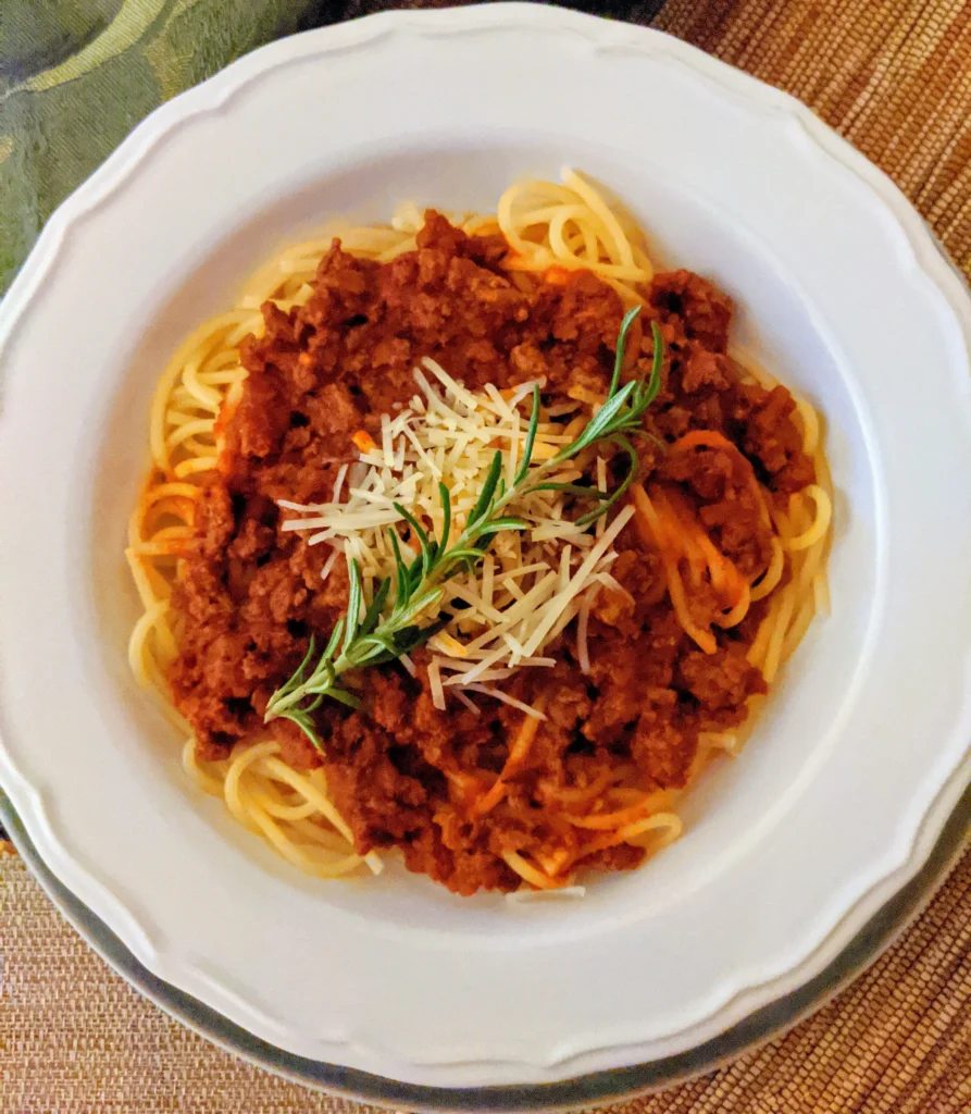 spaghetti carbonara dish topped with sauce meat